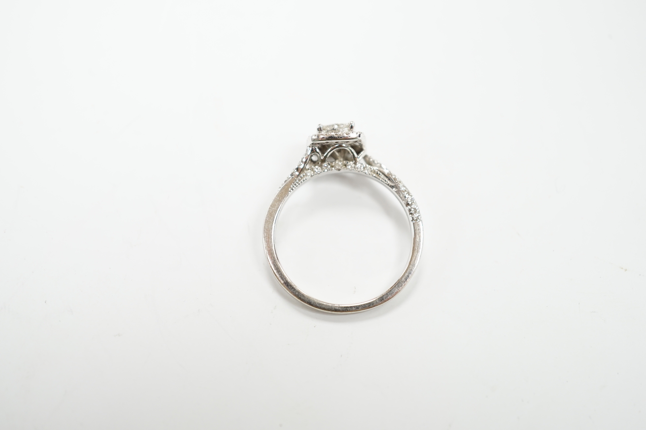 A modern 14ct white gold and diamond set cluster ring, size M/N, gross weight 2.7 grams.